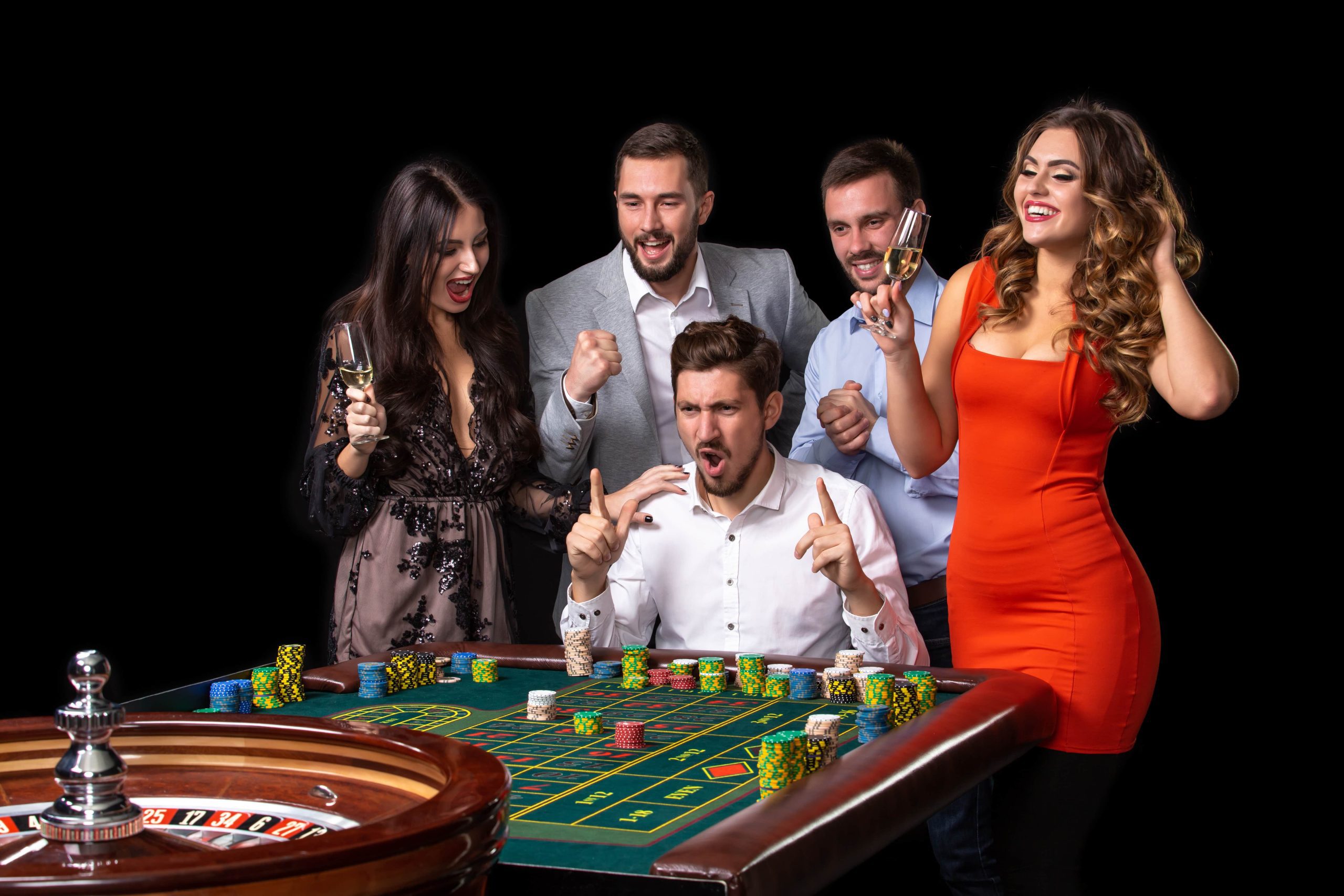 group young people looking excited spinning roulette roulette table casino black background min scaled